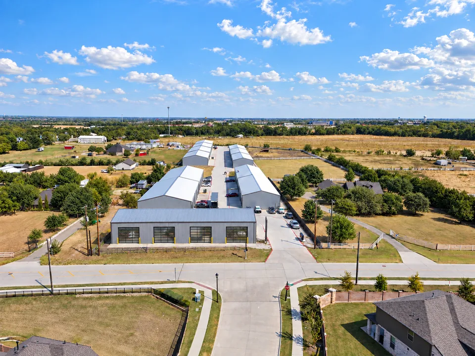 Melissa, Texas: the park entrance from above, glass bay doors across the front building