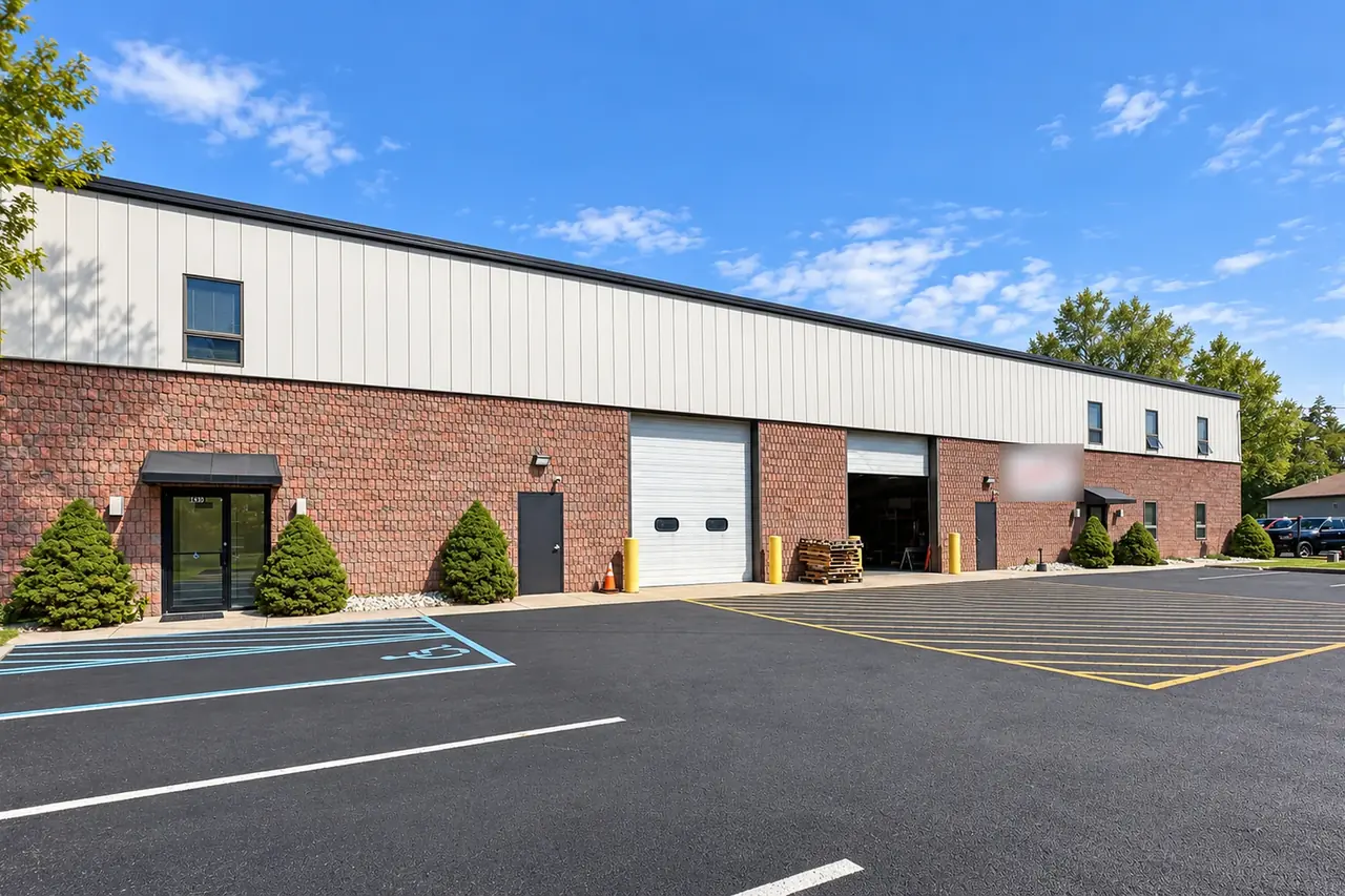 A brick and metal flex building with an office entrance and drive-in doors at United Flex Medford