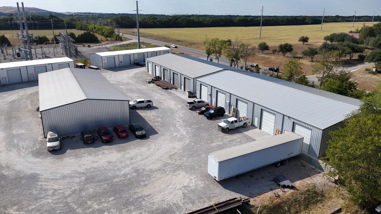 United Flex Anna from above: shop buildings around a gravel yard with work trucks and a trailer