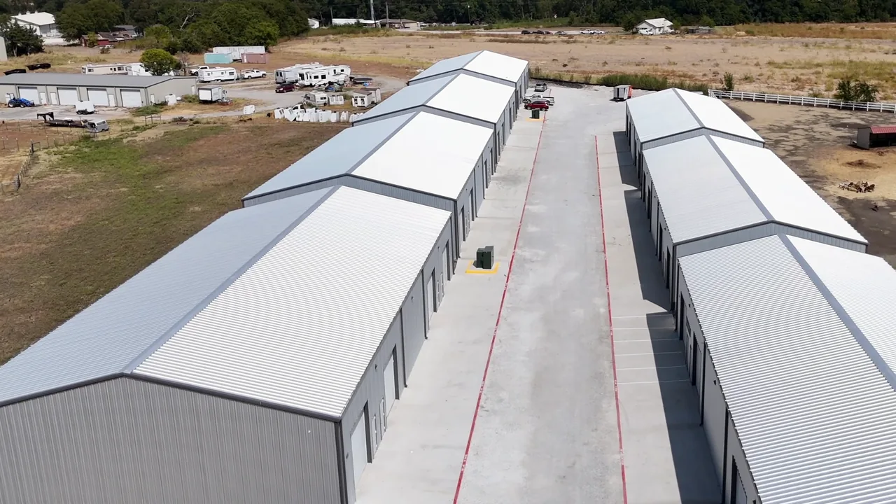A drive aisle between two rows of roll-up doors at United Flex Melissa, from above