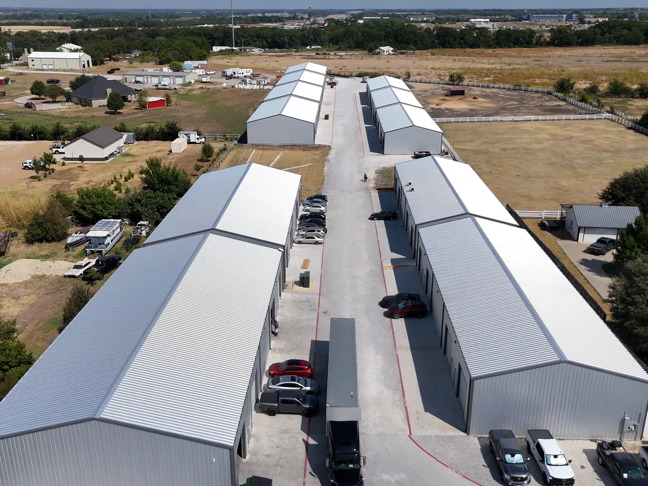 Work trucks and a semi trailer along a drive aisle at United Flex Melissa