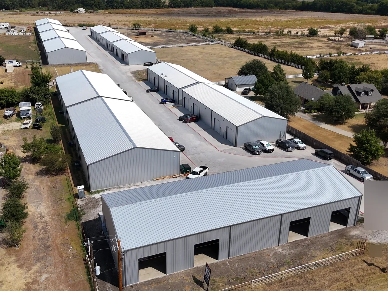 The front building's open bays and parking at United Flex Melissa, the rows behind