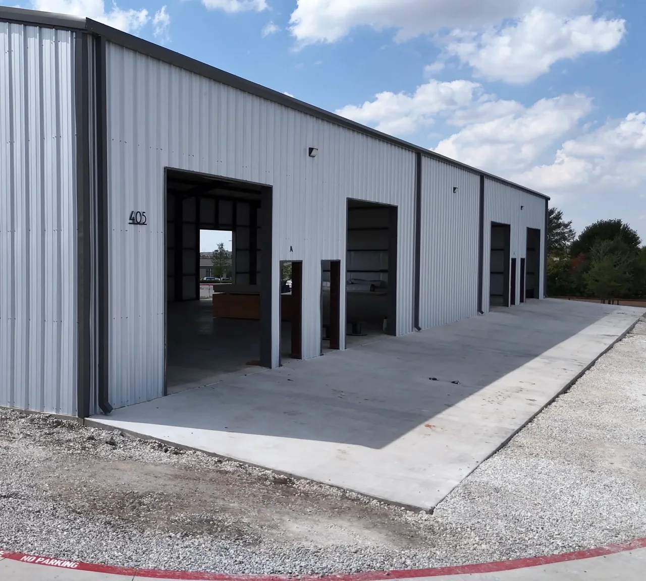 Open grade-level bay doors on a new building at United Flex Melissa