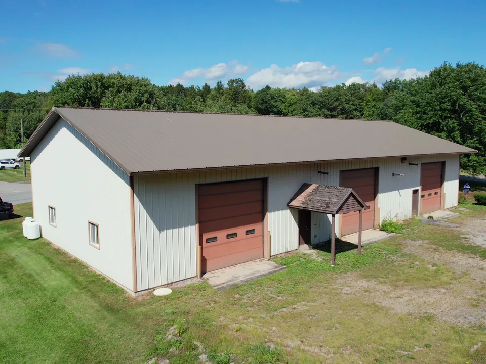 A shop building with grade doors and its yard at United Flex Westmoreland