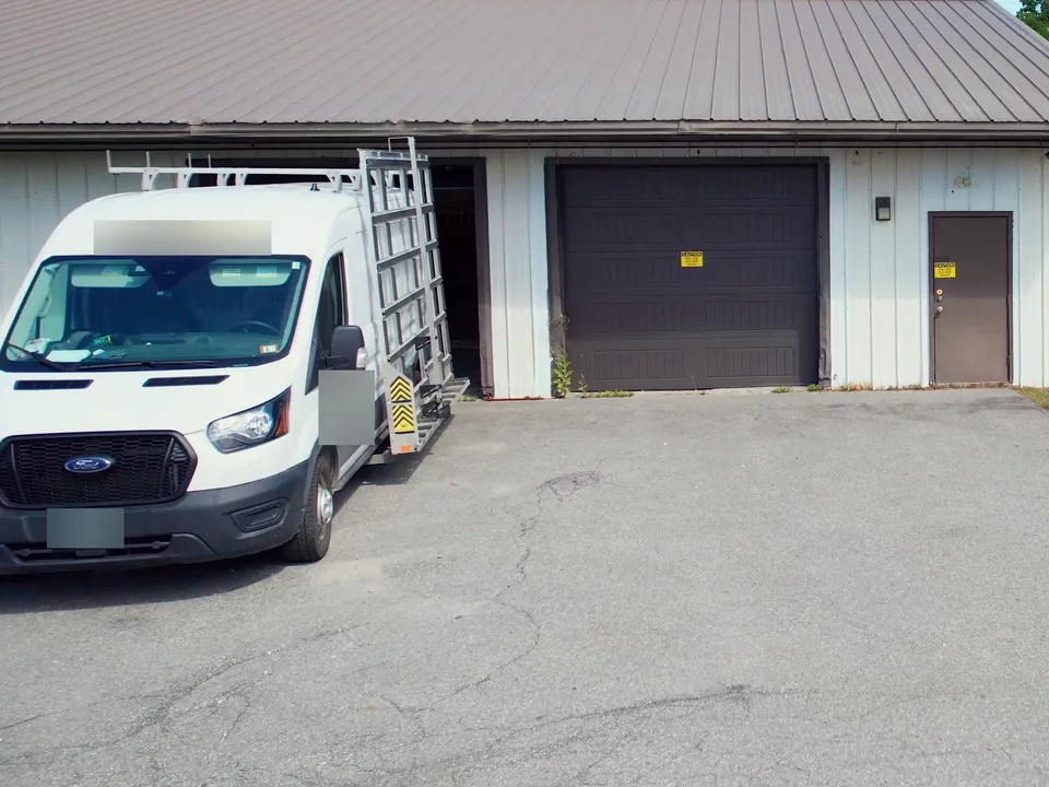 A contractor's van parked at an open bay door at United Flex Westmoreland