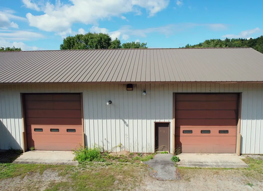 A United Flex Westmoreland building: two roll-up doors and a side door under a metal roof